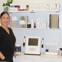 PureBeauty Spa esthetician beside treatment equipment