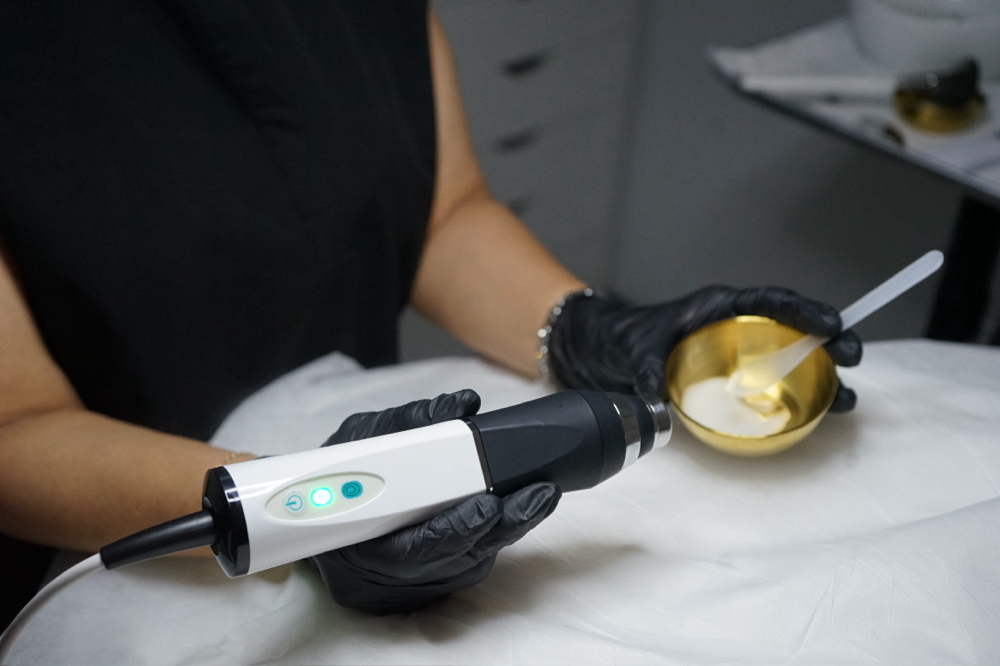 Esthetician preparing an advanced facial treatment at PureBeauty Spa